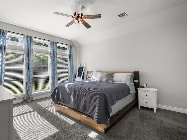 carpeted bedroom featuring baseboards, multiple windows, vaulted ceiling, and visible vents