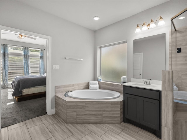 ensuite bathroom featuring vanity, ensuite bathroom, a bath, and a tile shower