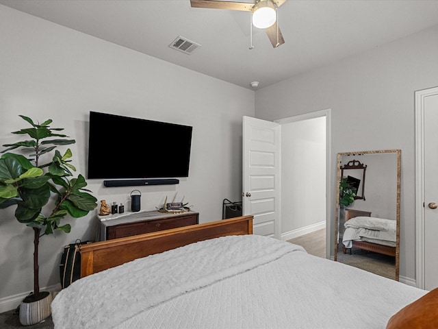 carpeted bedroom with baseboards, ceiling fan, and visible vents