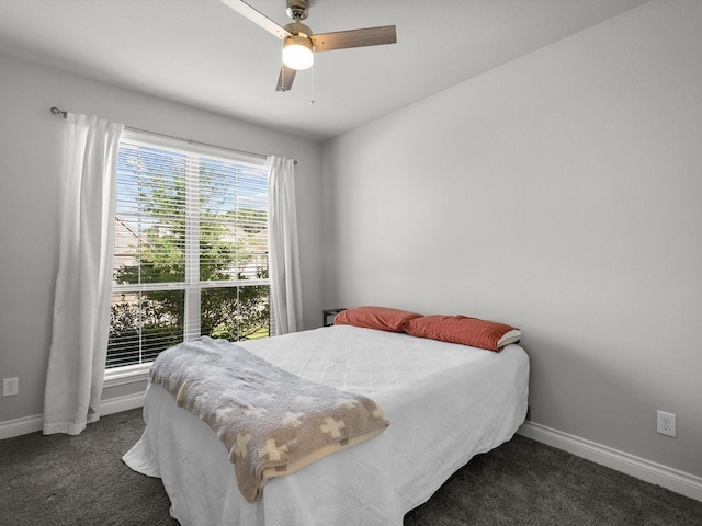 bedroom with baseboards, carpet flooring, and a ceiling fan