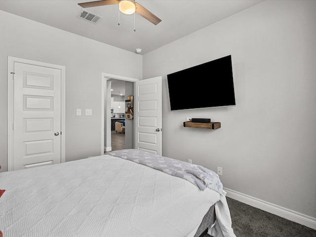 carpeted bedroom with a ceiling fan, baseboards, and visible vents