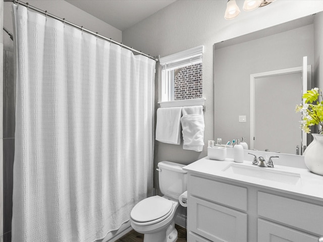 bathroom featuring toilet, a shower with curtain, and vanity