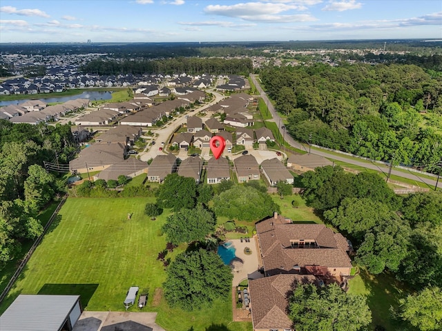 drone / aerial view with a water view and a residential view