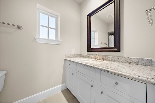 bathroom with vanity, tile patterned flooring, visible vents, toilet, and baseboards