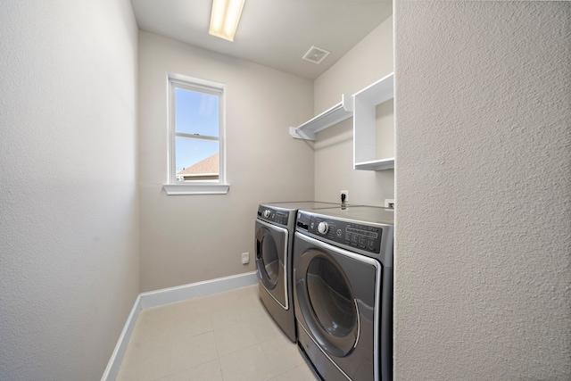 laundry room featuring laundry area, baseboards, washer and dryer, and visible vents