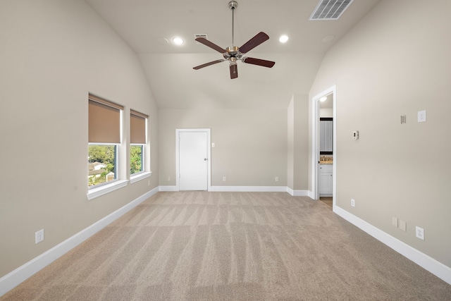 unfurnished room with visible vents, light carpet, baseboards, high vaulted ceiling, and a ceiling fan