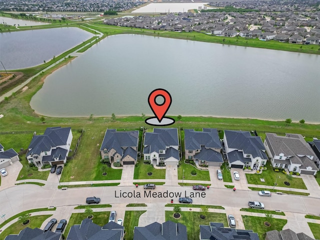 drone / aerial view featuring a water view and a residential view
