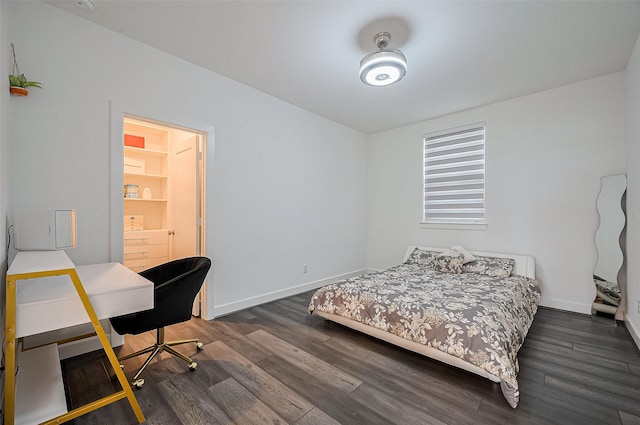 bedroom with baseboards and dark wood finished floors