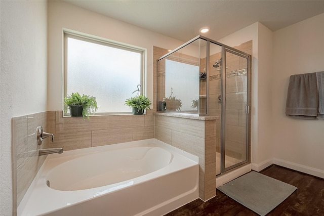 1219 Posey Ridge Trl, Katy, TX 77494 - bathroom featuring a garden tub, baseboards, a stall shower, and wood finished floors