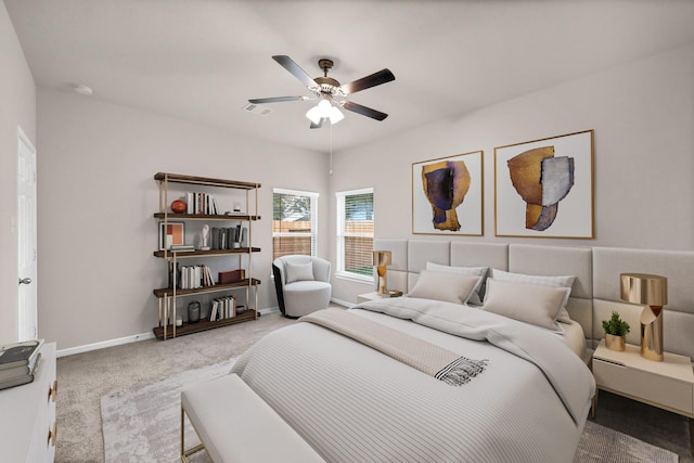 carpeted bedroom featuring baseboards, a ceiling fan, and visible vents