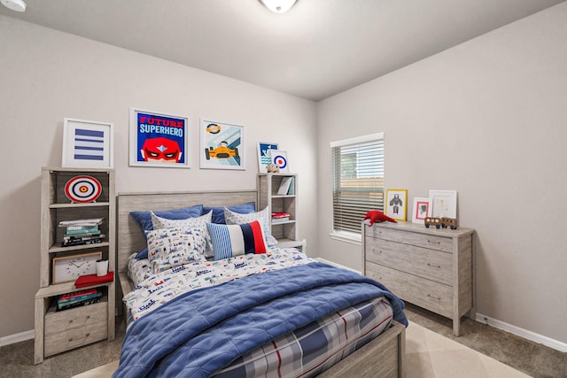 carpeted bedroom featuring baseboards
