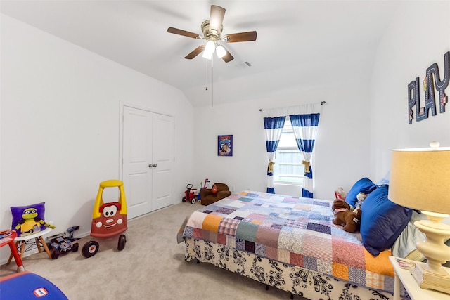 bedroom with visible vents, a closet, lofted ceiling, ceiling fan, and carpet flooring
