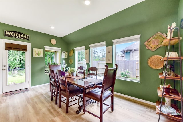 dining space featuring baseboards, vaulted ceiling, recessed lighting, and wood finished floors