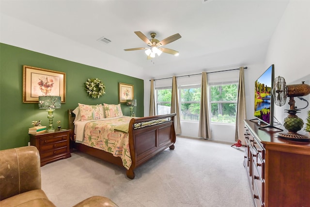 bedroom with ceiling fan, light carpet, and visible vents