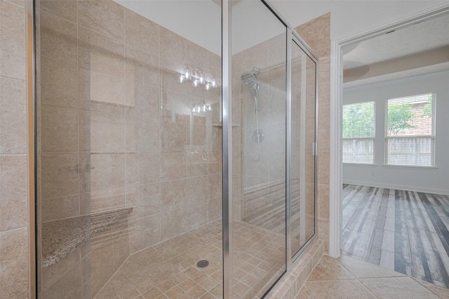 8135 W Pine Creek Bnd, Cypress, TX 77433 - bathroom featuring a stall shower, tile patterned flooring, and baseboards