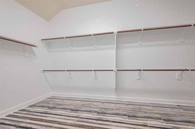 spacious closet with wood finished floors and lofted ceiling