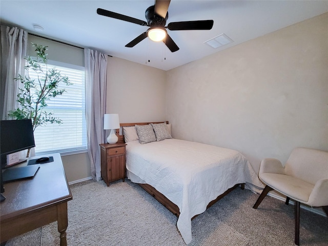 bedroom with light colored carpet, baseboards, visible vents, and multiple windows
