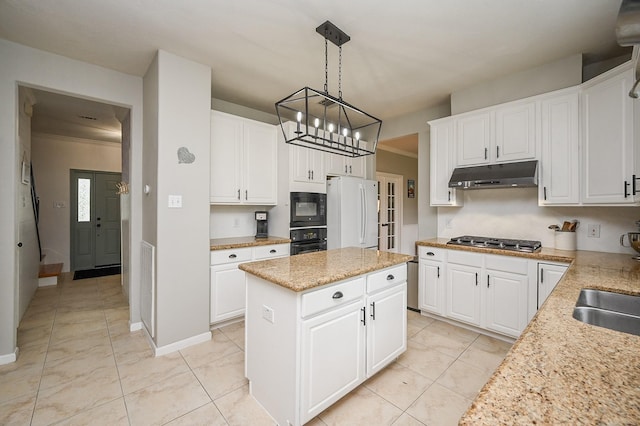 kitchen featuring a chandelier, a center island, white cabinetry, under cabinet range hood, and black appliances