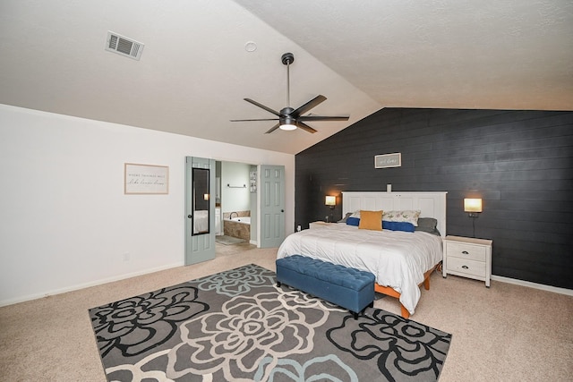 bedroom featuring light colored carpet, baseboards, visible vents, and lofted ceiling