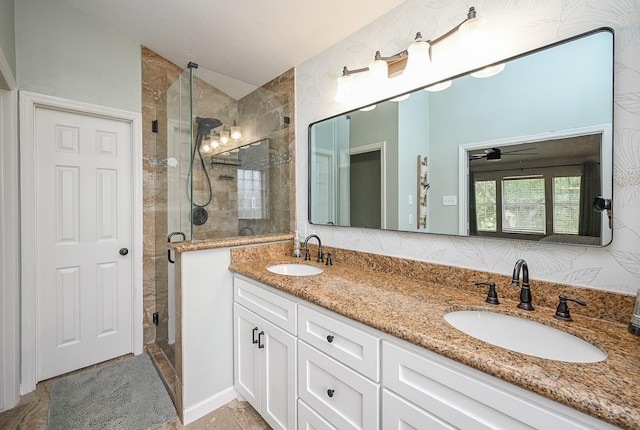 full bathroom featuring double vanity, a shower stall, a sink, and lofted ceiling