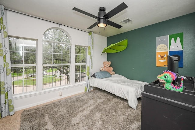 bedroom featuring a ceiling fan, baseboards, and visible vents