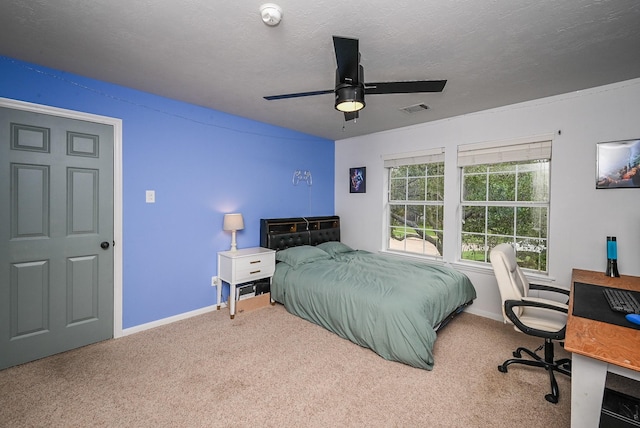 carpeted bedroom featuring baseboards, ceiling fan, and visible vents