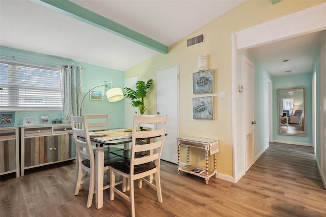 22118 Matagorda Dr, Galveston, TX 77554 - dining area featuring baseboards, lofted ceiling with beams, wood finished floors, and visible vents