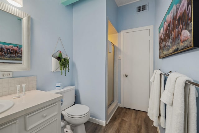 22118 Matagorda Dr, Galveston, TX 77554 - full bath featuring visible vents, a shower stall, wood finished floors, and vanity