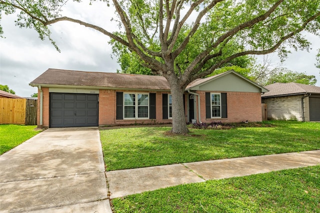 ranch-style house with an attached garage, a front yard, driveway, and brick siding