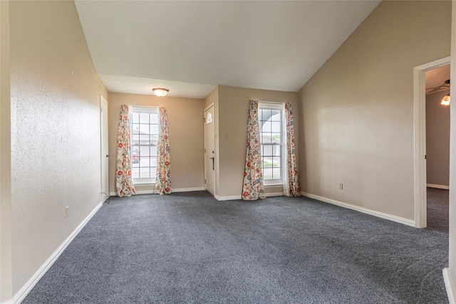 empty room featuring baseboards and dark colored carpet