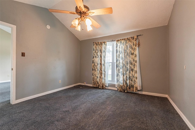 empty room with dark carpet, baseboards, ceiling fan, and vaulted ceiling