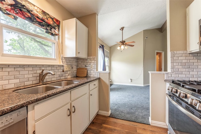 kitchen with decorative backsplash, a ceiling fan, white cabinetry, a sink, and stainless steel appliances