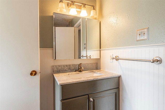 bathroom featuring wainscoting and vanity
