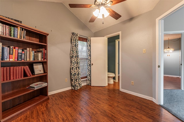 interior space with baseboards, ceiling fan, wood finished floors, and vaulted ceiling