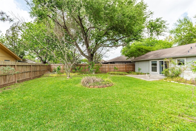 view of yard featuring a patio and a fenced backyard