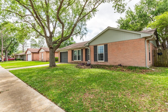 ranch-style house featuring fence, brick siding, a garage, a front yard, and driveway