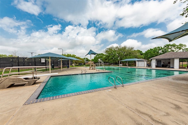 pool with fence and a patio
