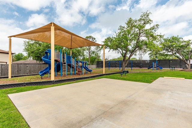 community play area featuring fence and a yard