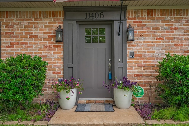 property entrance with brick siding