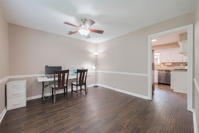 office area featuring baseboards, a ceiling fan, and dark wood-style floors