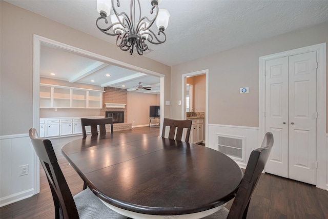 dining area with visible vents, wainscoting, dark wood-style floors, and a fireplace