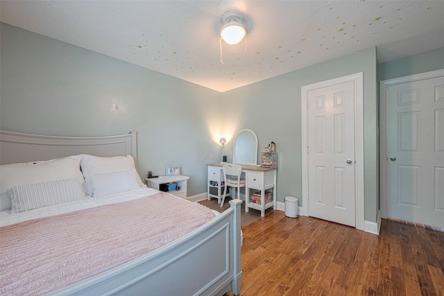 bedroom with baseboards, ceiling fan, and wood finished floors