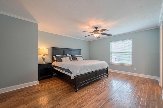 bedroom with ceiling fan, a textured ceiling, baseboards, ornamental molding, and hardwood / wood-style flooring