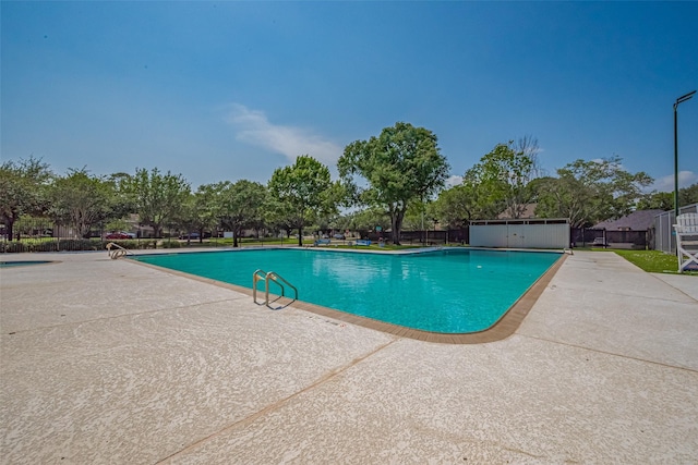 community pool featuring fence and a patio area