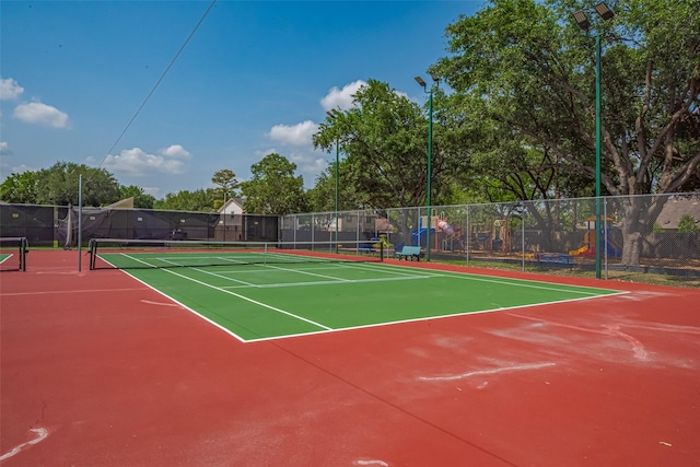 view of tennis court featuring fence and community basketball court
