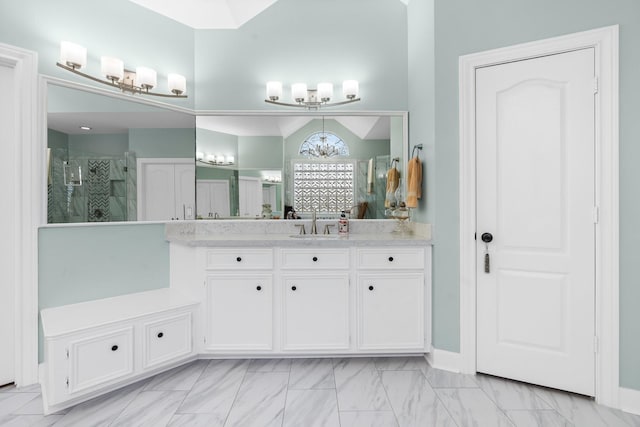full bath featuring vanity, a notable chandelier, and a stall shower