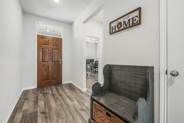 entryway featuring baseboards, ceiling fan, and wood finished floors