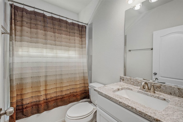 bathroom with vanity, shower / tub combo, and toilet
