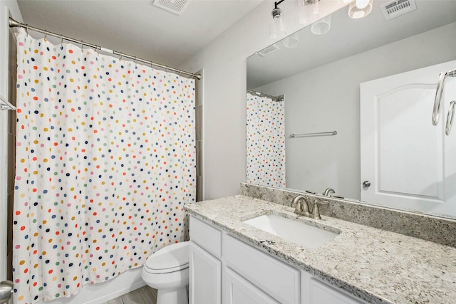 full bathroom featuring toilet, visible vents, and vanity