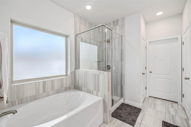 full bath featuring tile patterned flooring, a shower stall, recessed lighting, and a garden tub